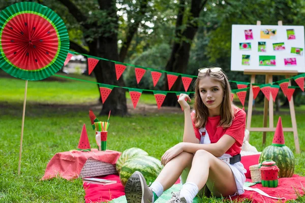 Nice teen girl having fun watermelon party In the park. Excellent sunny weather. Summer concept. Watermelon party, picnic, day. — ストック写真