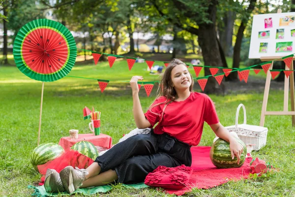 Nice teen girl having fun watermelon party In the park. Excellent sunny weather. Summer concept. Watermelon party, picnic, day. — 图库照片