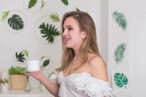 Mujer Joven Bebiendo Sentado Hermoso Interior Con Flores Verdes Fondo —  Fotos de Stock