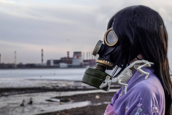 Concept of coronavirus quarantine. A girl in a Korean national dress and gas mask with rat skeleton during covid-19 coronavirus global pandemic warning and danger. Ecological problem