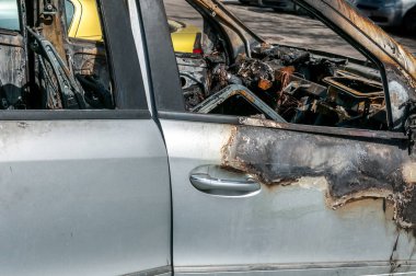 Yeni pahalı yanmış araba park yerinin seçici odak üzerinde yangında toplam hasar