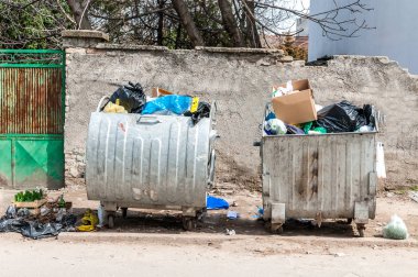Büyük metal çöp bidonuna çöp önemsiz şehir sokakta kirletici ve taşma çöp dolu