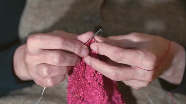 寒い冬の日のための暖かいセーターの仕事のための編み針と色のウールを保持している老婦人の手を閉じる選択的な焦点 女性の編み物 — ストック動画