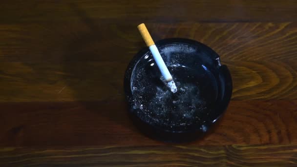 Dirty Black Ceramic Ashtray Ash Burning Smoking Cigarette Wooden Bar — Stock Video