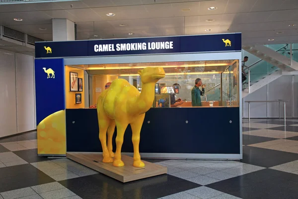 Kamelraucherlounge mit Passagieren im Inneren des Flughafens München, Deutschland — Stockfoto