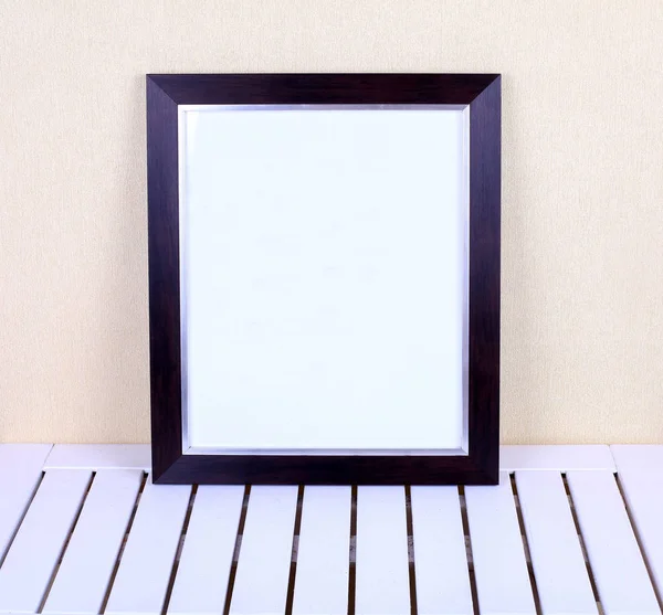 Black frame on wooden table in modern interior — Stock Photo, Image