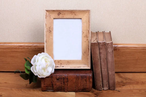 Vintage wood frame with old books on table. — Stock Photo, Image