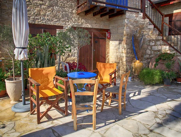 Table and outdoor chairs on terrace with flower pots — Stock Photo, Image