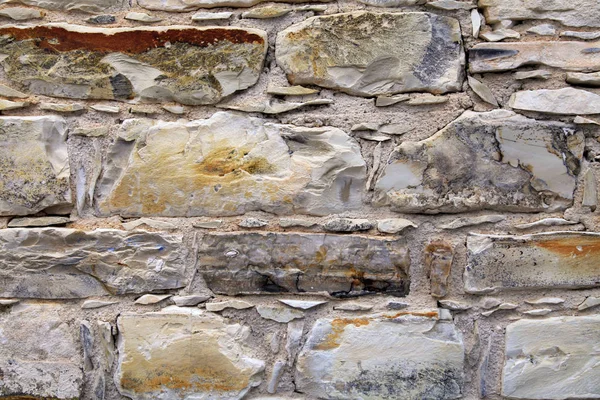 Średniowiecznego kamiennego muru teksturowanej tło. — Zdjęcie stockowe