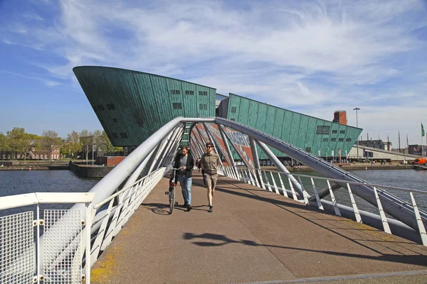 Les gens marchent sur le pont moderne près du musée Nemo à Amsterdam — Photo
