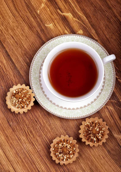 Cup of tea with cakes on a wooden background — Stock Photo, Image