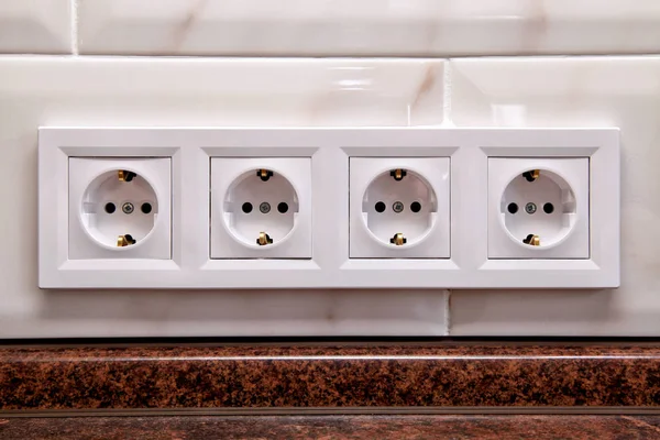 Electrical sockets on a kitchen tile wall — Stock Photo, Image