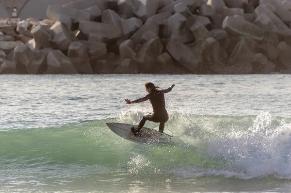 Surfer riding the waves of the sea