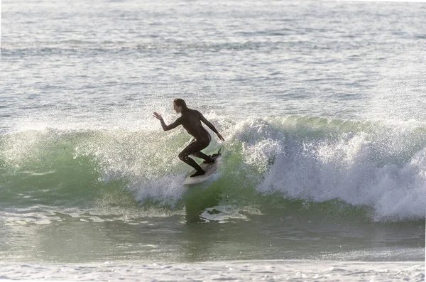 Surfer riding the waves of the sea