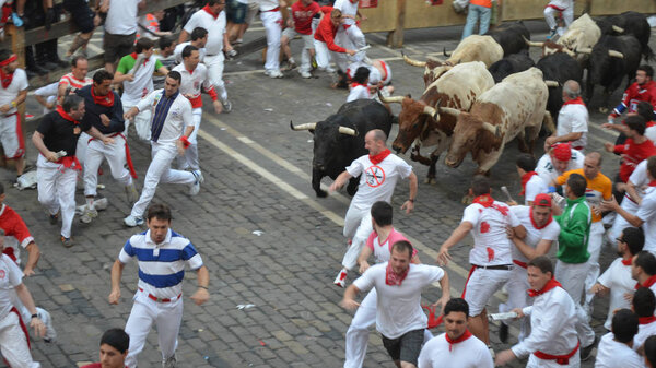Crowds participate in the annual running of the bulls. San Fermin festival, Pamplona, Spain - July 10, 2013