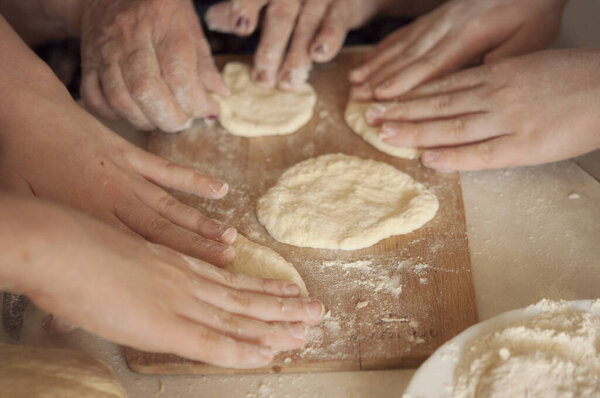 children's hands makes raw dough