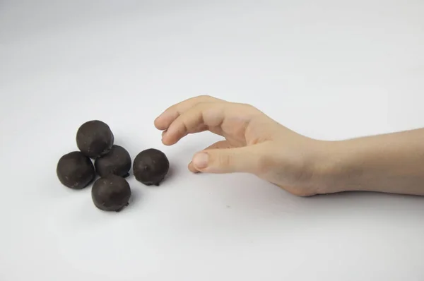 Child\'s hand reaching for sweets, all on a white background.