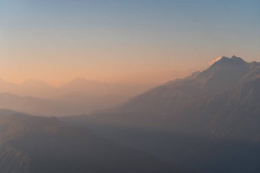 Dağlarda gün batımı. Sisin içindeki dağ manzarası