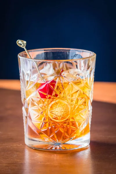 Old fashioned cocktail on a wooden table isolated on background