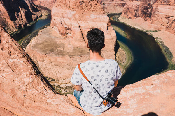 young man with Magnificent view of Horseshoe Bend, Grand Canyon, Arizona, USA.