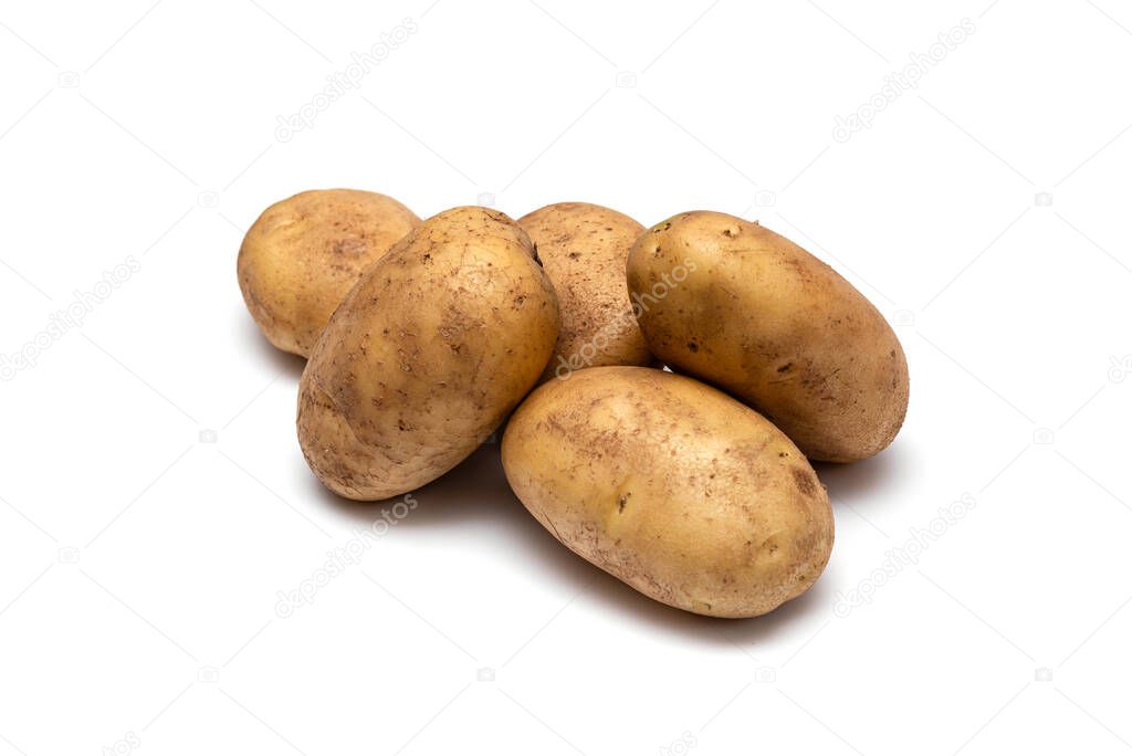 several raw dirty potatoes on a white background