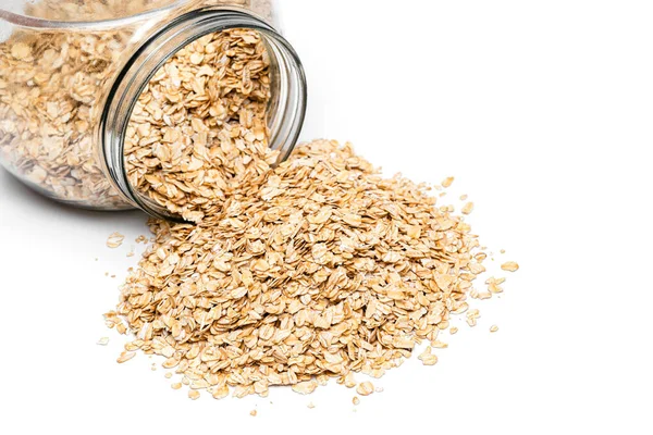 Oatmeal Spilled Out Glass Jar White Background — Stock Photo, Image