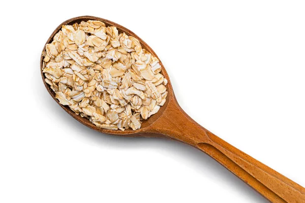 oat flakes in wooden spoon on a white background
