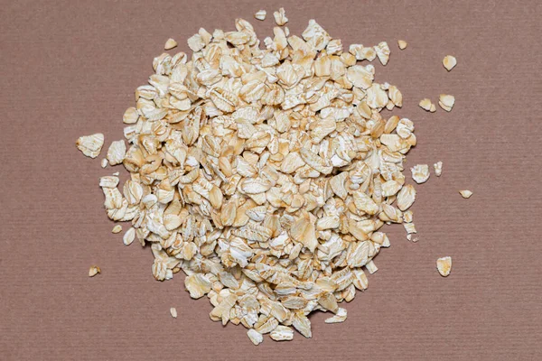 oat flakes on a brown background