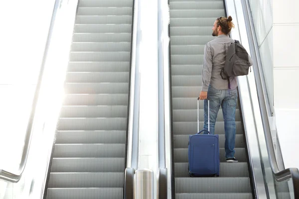 Viajando homem subindo escada rolante — Fotografia de Stock