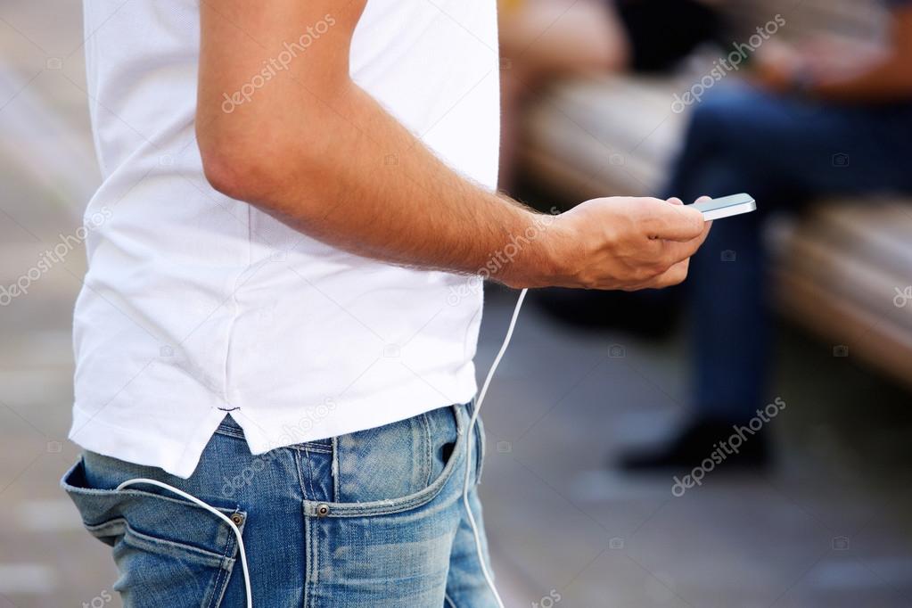 Man walking with cell phone and external battery
