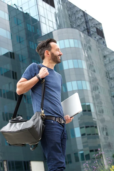 Ler mogen man promenader utomhus med handväska — Stockfoto