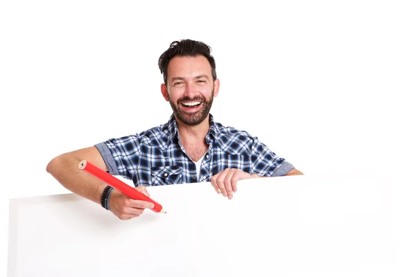 Laughing mature man writing over blank poster — Stock Photo, Image