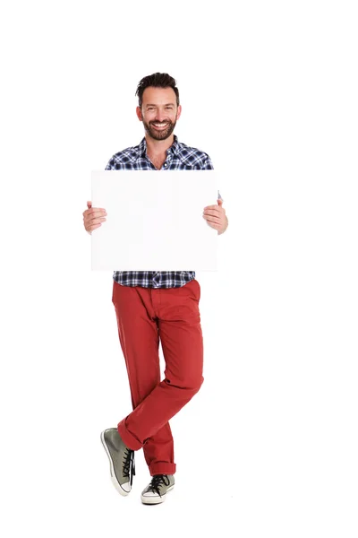 Hombre guapo sosteniendo cartel en blanco sobre fondo blanco — Foto de Stock