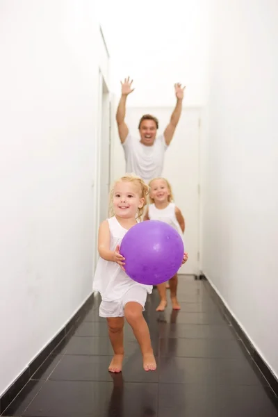 Cheerful young family playing at home — Stock fotografie