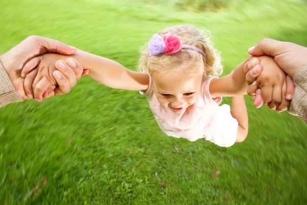 Little girl being spun in circles — Stock Photo, Image