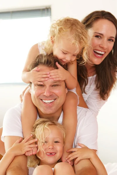 Hermosa familia joven sonriendo en casa — Foto de Stock