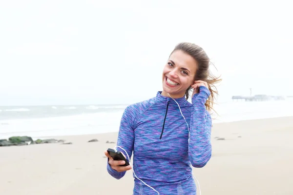 Mulher na praia com fones de ouvido — Fotografia de Stock