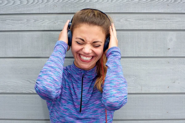 Woman with hands on headphones — Stock Photo, Image