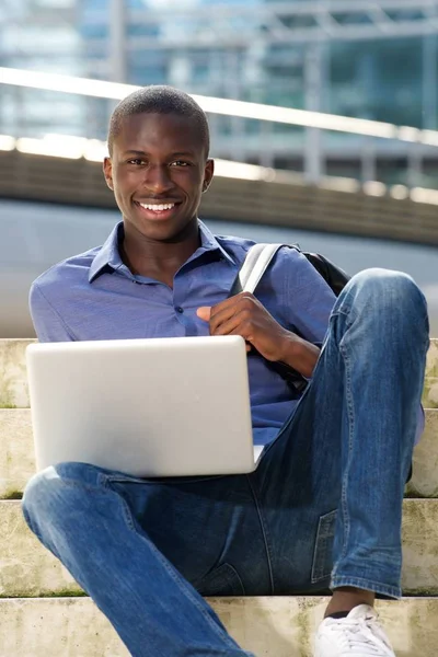 African man outdoors with laptop — Stock Photo, Image