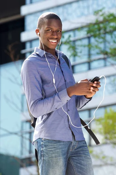 Guy listening music on earphones — Stock Photo, Image