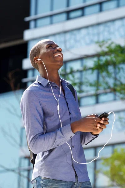 Guy listening music on earphones