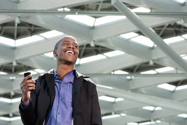 Man walking with phone at station — Stock Photo, Image