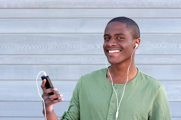 African guy smiling with earphones — Stock Photo, Image