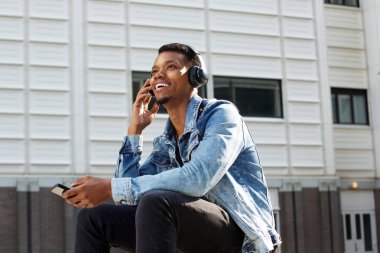 Telefon ile merdivenlerde oturan adam 