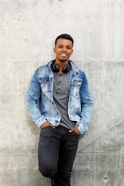 Man with jeans jacket and headphones