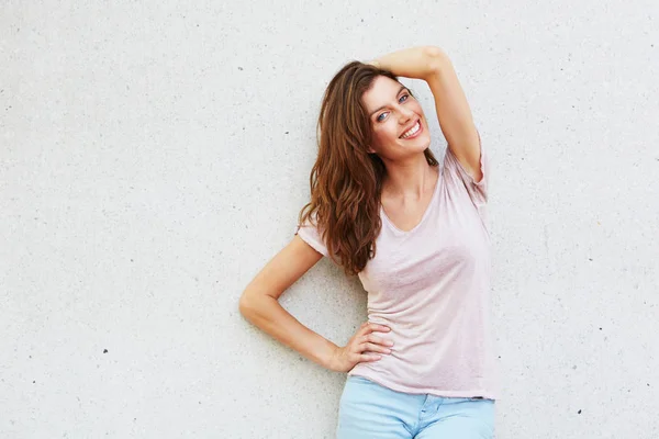 Young woman against wall — Stock Photo, Image