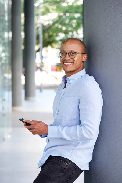 Geschäftsmann lächelt mit Handy — Stockfoto