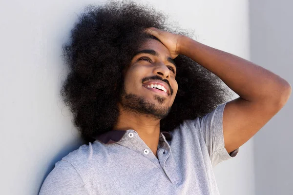 Man with hand in hair looking away — Stock Photo, Image