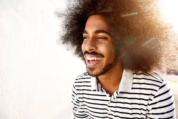 Laughing afro man in sunlight — Stock Photo, Image