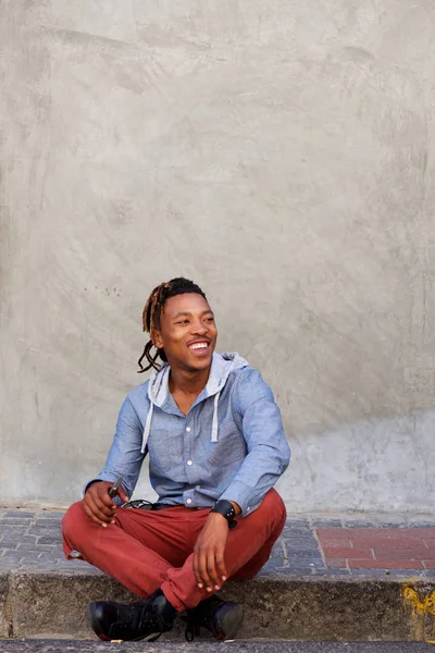 Man sitting outside on sidewalk — Stock Photo, Image